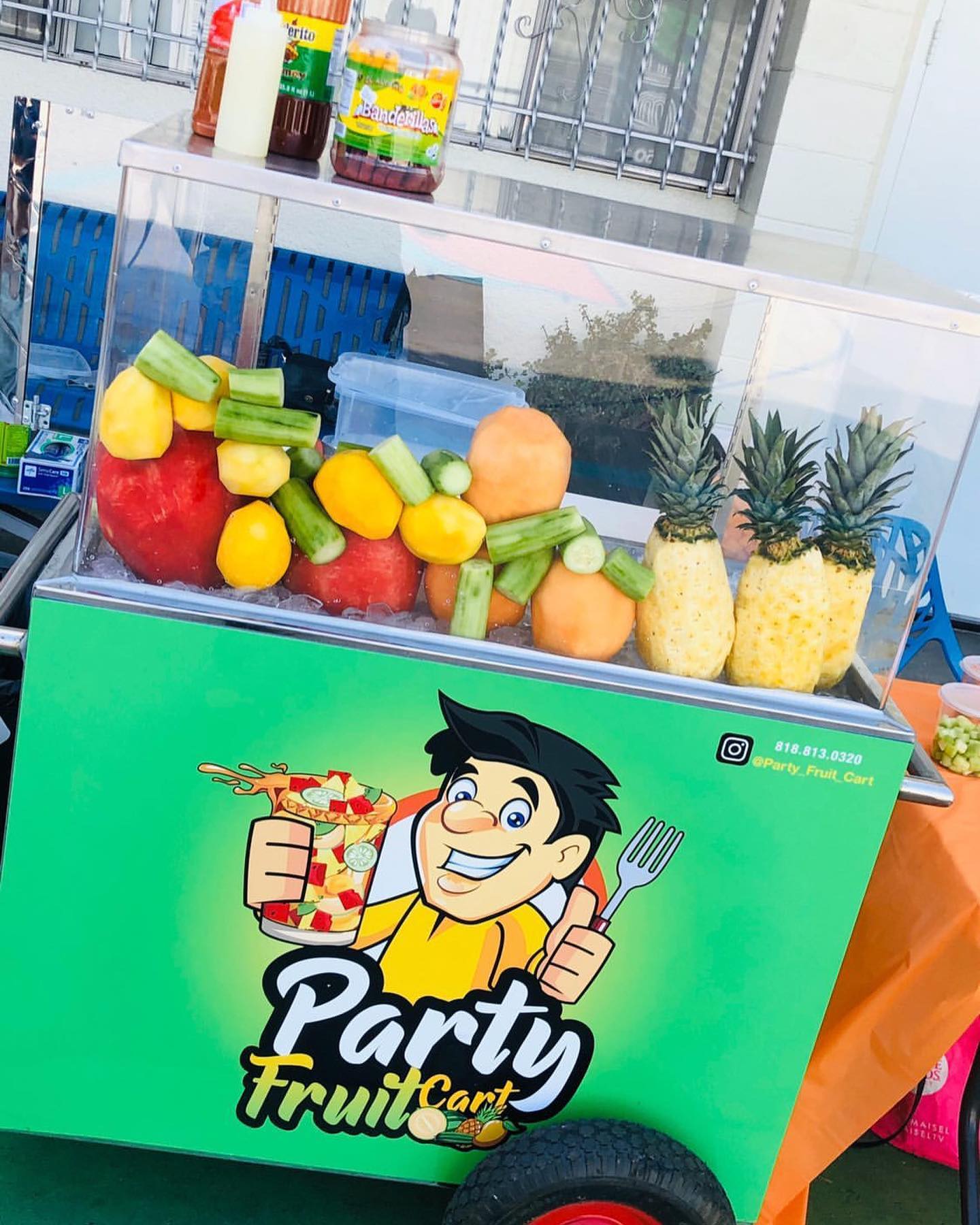 Party Fruit Cart stocked with fresh pineapple, mango, and watermelon