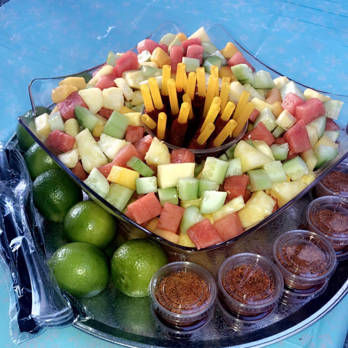 Fruit platter with watermelon, pineapple, mango, and chili seasoning