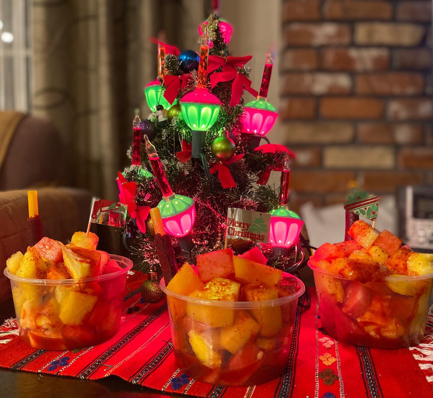 Holiday fruit cups with chili seasoning and tamarind straws